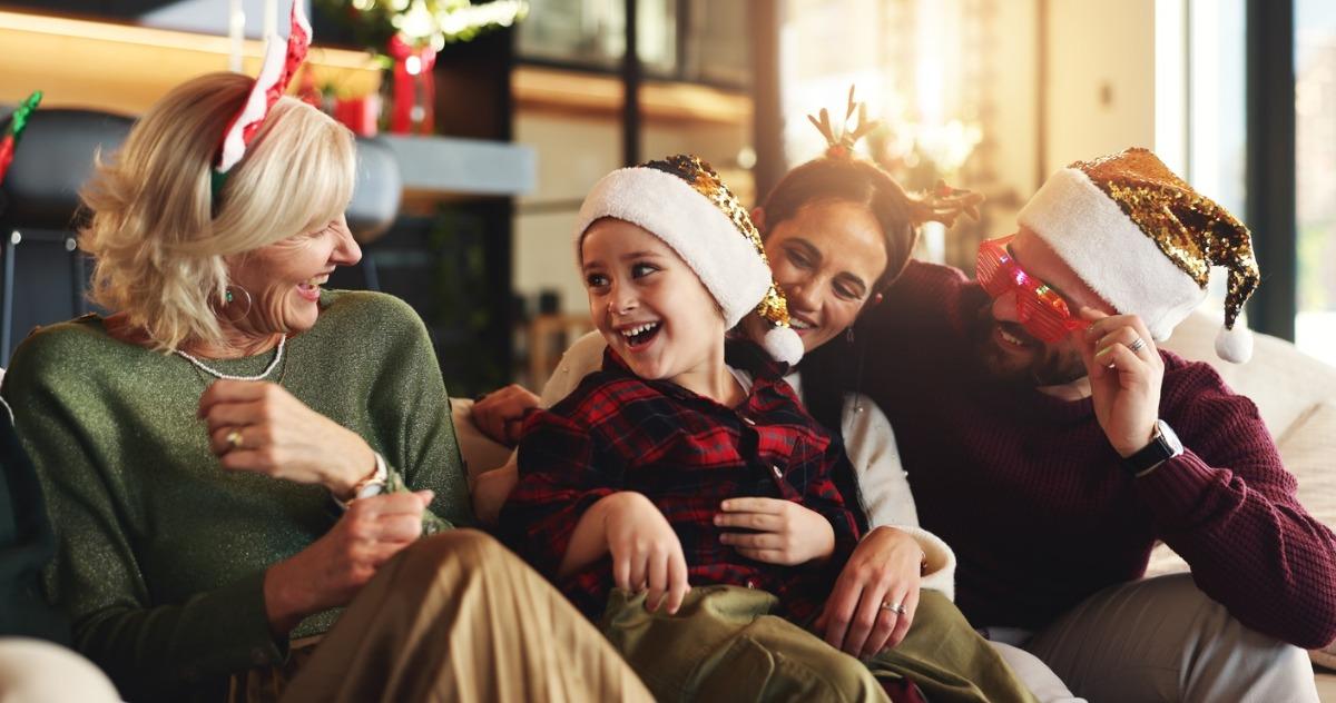 Family, generations and child on sofa for Christmas, festive season and bonding on holiday