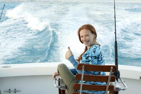 Woman fishing on boat